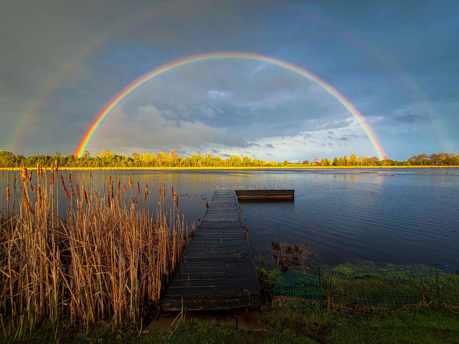 double rainbow over a dock